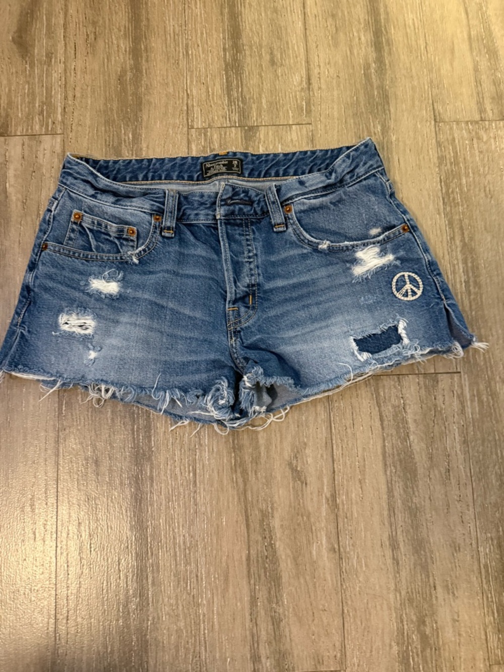 Abercrombie & Fitch Distressed Blue Denim Shorts with Peace Patch.